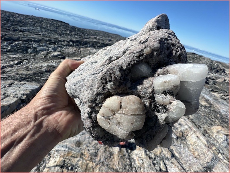Clusters of large crystals appear in this rock sample that has been shaped and reworked over time. Rock Crystals