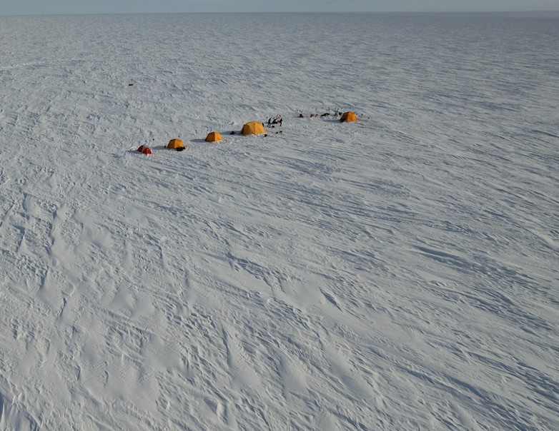 Camp site one from above. Yellow tents appear small on the icesheet but the yellow color helps them stand out. Camp