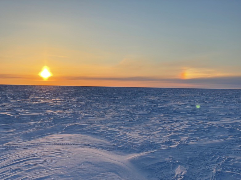 The colors of the sun, sky and ice as the sun hangs low in the sky. Sun on the horizon