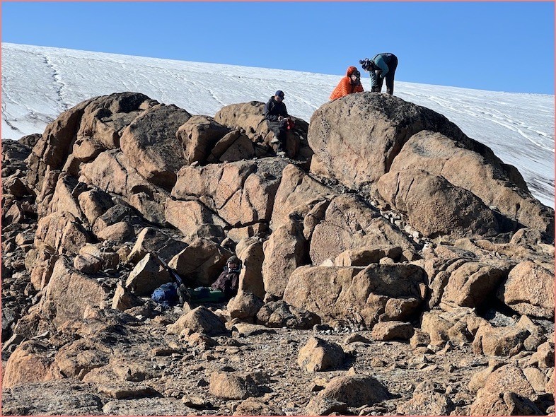 Sampling rock at glacier edge
