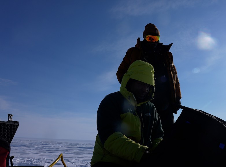 A small, concentrated explosive (PETN) is lowered into the ice, that when triggered, sends sound vibrations down into the ice. Setting small seismic explosions