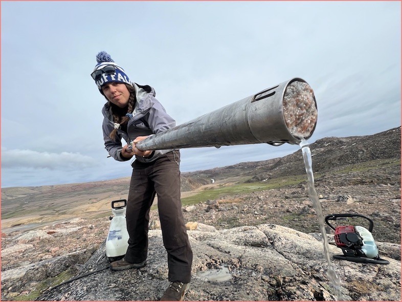 Karlee Prince holds a freshly drilled rock core